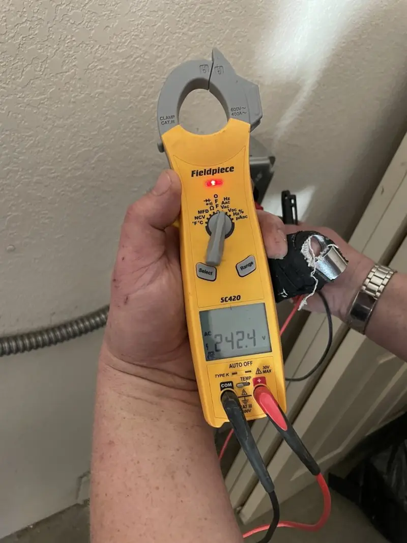Voltage testing with clamp meter during Recessed Lighting Installation in Mahomet